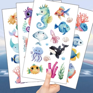 Close-up of colorful ocean animal temporary tattoos featuring seahorses and mermaids