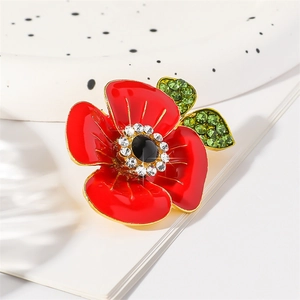 Poppy flower brooch with red enamel petals, green crystal leaves and gold metal plating