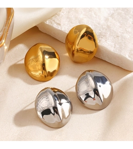 Close-up of geometric oval button earrings in polished gold and silver steel finish