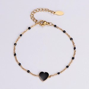 Macro shot of 18k gold plated lobster clasp and black heart pendant on a thin chain