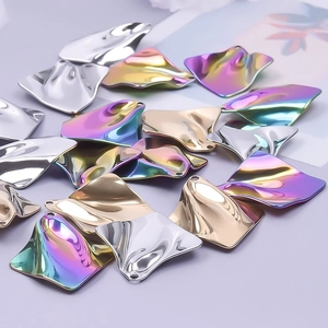 Detailed view of DIY wavy metal pendants in gold silver and iridescent finishes