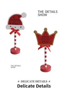 Close-up of wooden Christmas North Pole and Santa Stop Here signs with LED lights