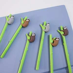 Close-up of cute cartoon sloth topper on green bamboo shaped student gel ink pen