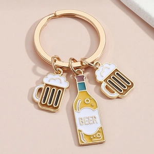 Detail of beer-themed keychain featuring gold-finish mugs and an enamel beer bottle