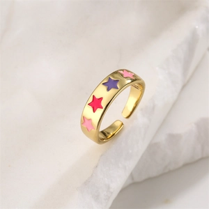 Macro shot of gold-plated open ring with colorful enamel stars and cubic zirconia