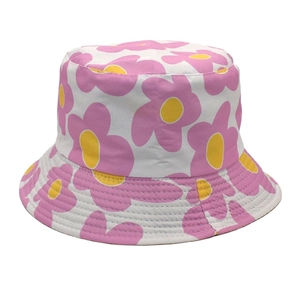 Close-up of reversible bucket hat featuring white base with pink and yellow floral pattern