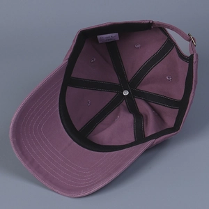 Internal view of purple cotton baseball cap showing black reinforcement and washing label