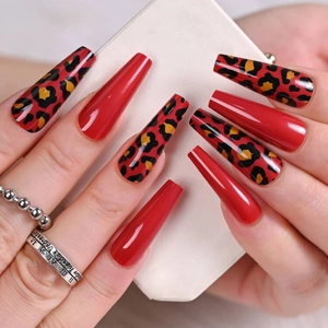 Long coffin shape fake nails featuring red glossy finish and leopard print details