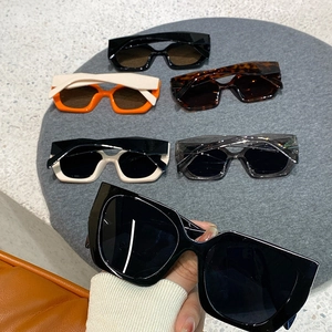 Close-up of stylish thick-frame polygonal sunglasses in various trendy colors
