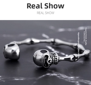 Macro shot of polished stainless steel gothic skull bracelet with skeleton bone design