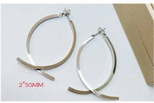 Detail showing minimalist 2x50MM silver hoop earrings on a clean white surface