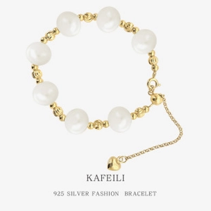 Detail of S925 silver bracelet with white freshwater pearls and golden hollow beads