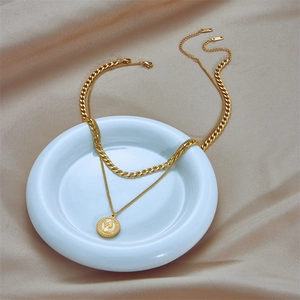 Double-layered gold chain necklace featuring a vintage queen portrait coin pendant