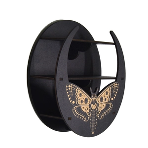 Detail of black moon-shaped wooden shelf with butterfly pattern and multiple display tiers