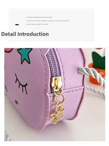 Detailed view of purple unicorn purse featuring a gold bow pendant and woven rope strap