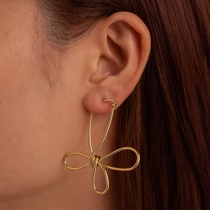 Chic 18K gold plated stainless steel knotted petal earrings worn by a female model