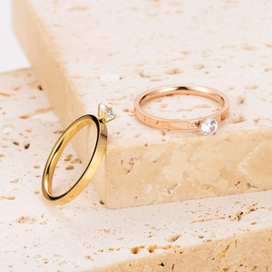 Elegant gold and rose gold rings with roman numerals and sparkling zircon stones
