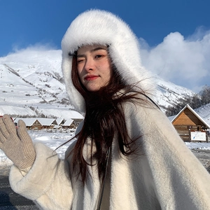 Close-up of soft white faux fur texture and warm beige knitted gloves for winter