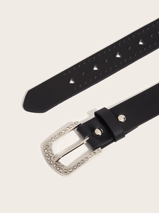 Detail of black leather belt with silver rhinestone buckle and heart cut-out patterns