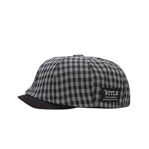 Retro black and white checkered newsboy hat with stitched patch and black brim