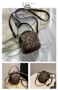 Detailed views of dark brown leopard print cylindrical handbag with gold hardware