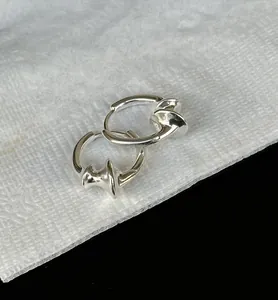 Detail view of 925 sterling silver hoop earrings with elegant twisted spiral design