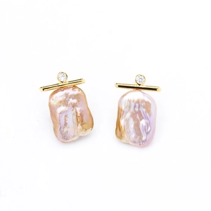 Macro detail of baroque pearls with golden accents and sparkling zircon studs
