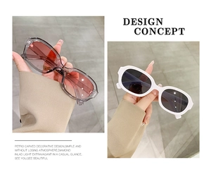 Detail view of retro oval sunglasses showing glossy frames and gradient lenses