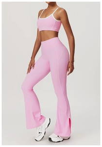 Pink yoga set featuring contrast stitching top and split-hem flared leggings detail