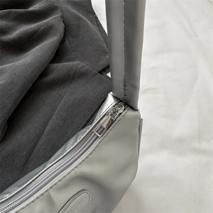 Silver metallic pleated crescent shoulder bag with detailed zipper and fine stitching