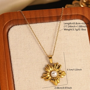 Macro view of gold flower necklace with white pearl and detailed size measurements