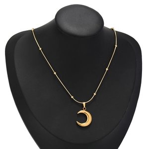 Gold stainless steel crescent moon pendant necklace with small beads on black neck bust