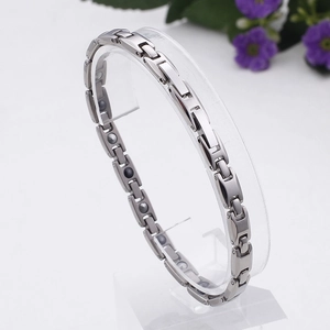 Macro detail of silver titanium steel magnetic link bracelet with germanium stone inserts
