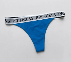 Detailed view of blue cotton thong with wide elastic lettered PRINCESS waistband