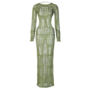 Detail of olive green knit dress showing intricate hollow out patterns and texture