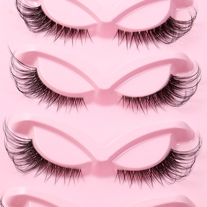 Dramatic fox-eye false eyelashes with clear bands and cat-eye curls in pink tray
