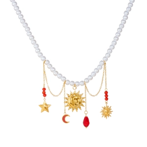 Elegant pearl necklace with celestial charms featuring sun, moon, and red droplet pendants