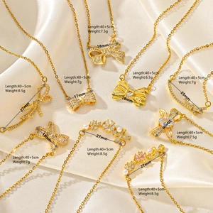 Detailed collection of gold butterfly necklaces on satin with product dimensions