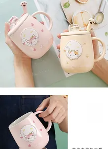 Detail of ceramic cat mugs with matching paw spoons and embossed kitten designs