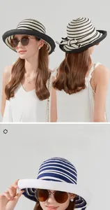 Detail of summer straw sun hat featuring elegant black, white, and blue stripe patterns
