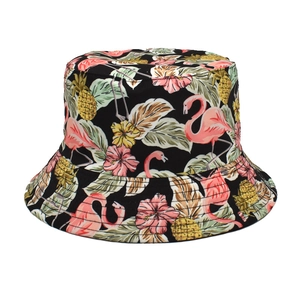 Detailed view of black bucket hat with pink flamingo and tropical pineapple prints