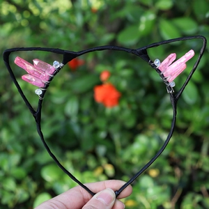 Detail of handmade cat ear headband with pink crystals and black wire frame