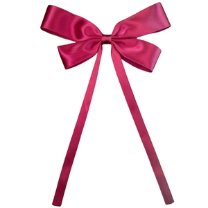 Detail of elegant magenta satin ribbon hair clip with smooth glossy finish and long tails