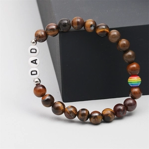 Detail view of tiger eye beads bracelet with DAD letter beads and rainbow accent