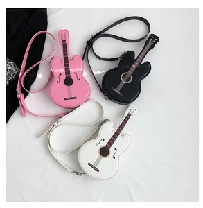 Detailed overhead view of violin-shaped crossbody bags in pink, black, and white colors
