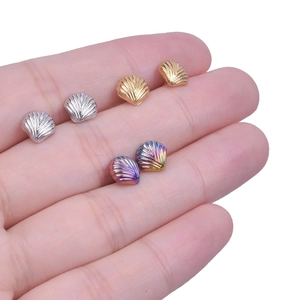 Macro shot of 304 stainless steel shell stud earrings in gold, silver, and iridescent colors