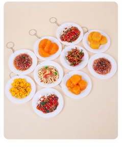 Detailed top view of 10 miniature resin food keychains on white trays with metal rings