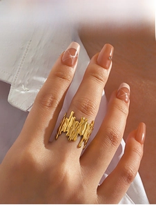 Detail of gold lava textured wide ring with irregular organic lines on finger