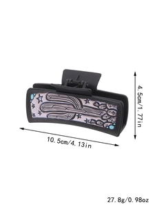 Detailed view of black hair claw clip with cactus pattern and measurement dimensions