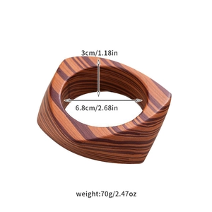 Detail view of square wood bangle showing dimensions, texture, and natural grain